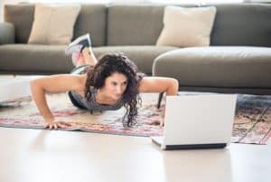 She is working in the morning while donning a t-shirt and a pair of pants.