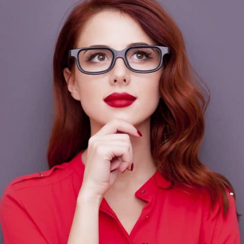 A silent working woman is posing for the picture while also looking stunning.