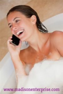 Telephone Work A woman in a black dress who is also using her phone was lying in the bathtub.