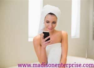 In this picture, a pretty woman is sitting and watching the phone while holding a towel. She is called a "Phone Sex Operator."