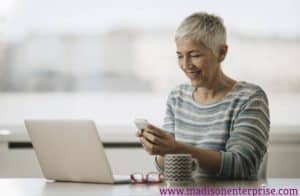 An attractive granny is posing for the camera in the image. She is working as a sex worker.