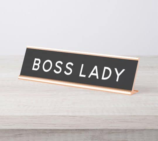 The image and board in the image both refer to a boss lady.